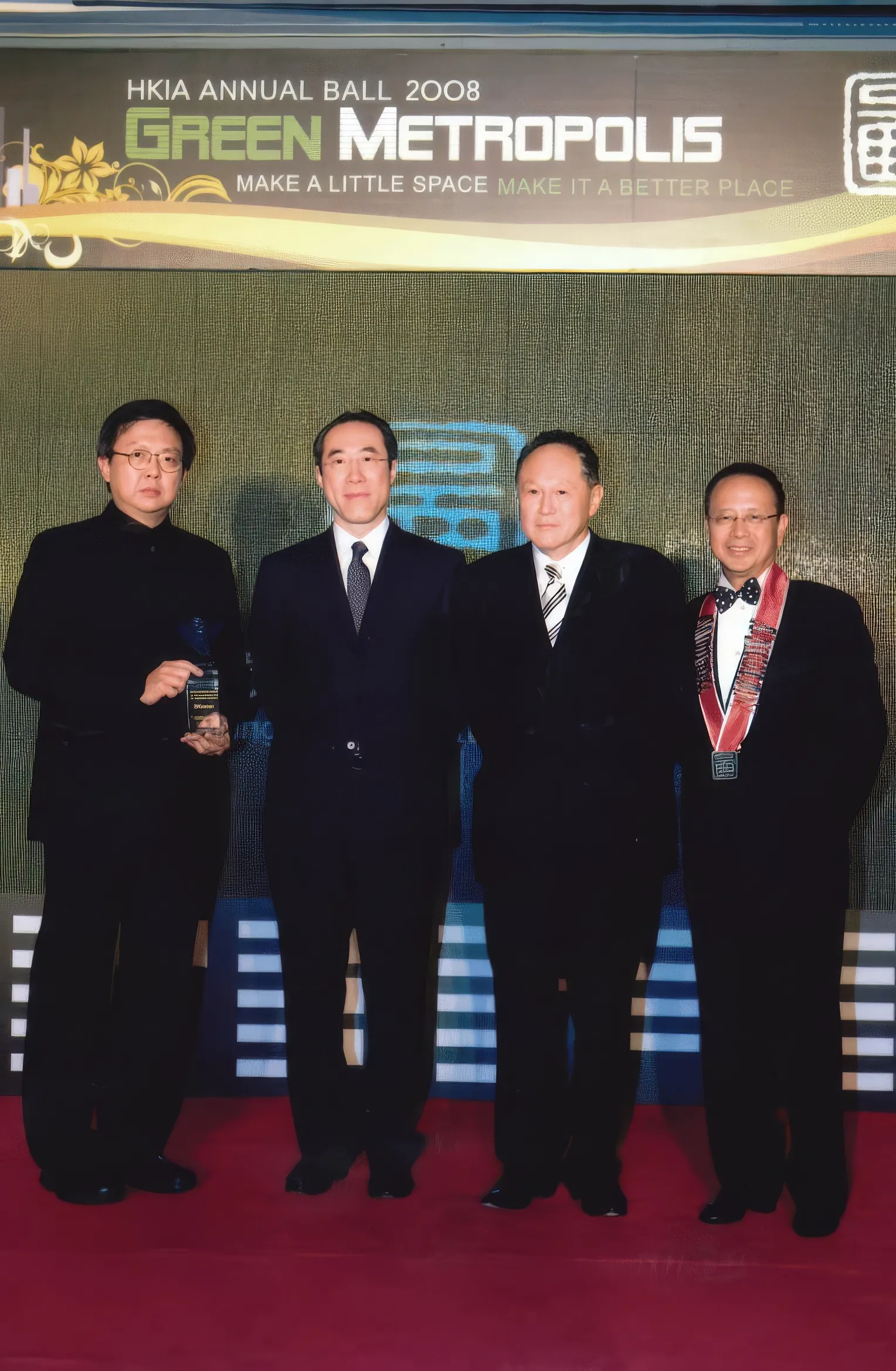 A photo of Dr. Cecil Chao with Mr. Henry Tang and friends during an event.