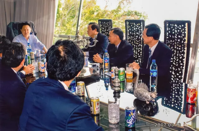 Dr. Cecil Chao disucssing project details with a group of colleagues.