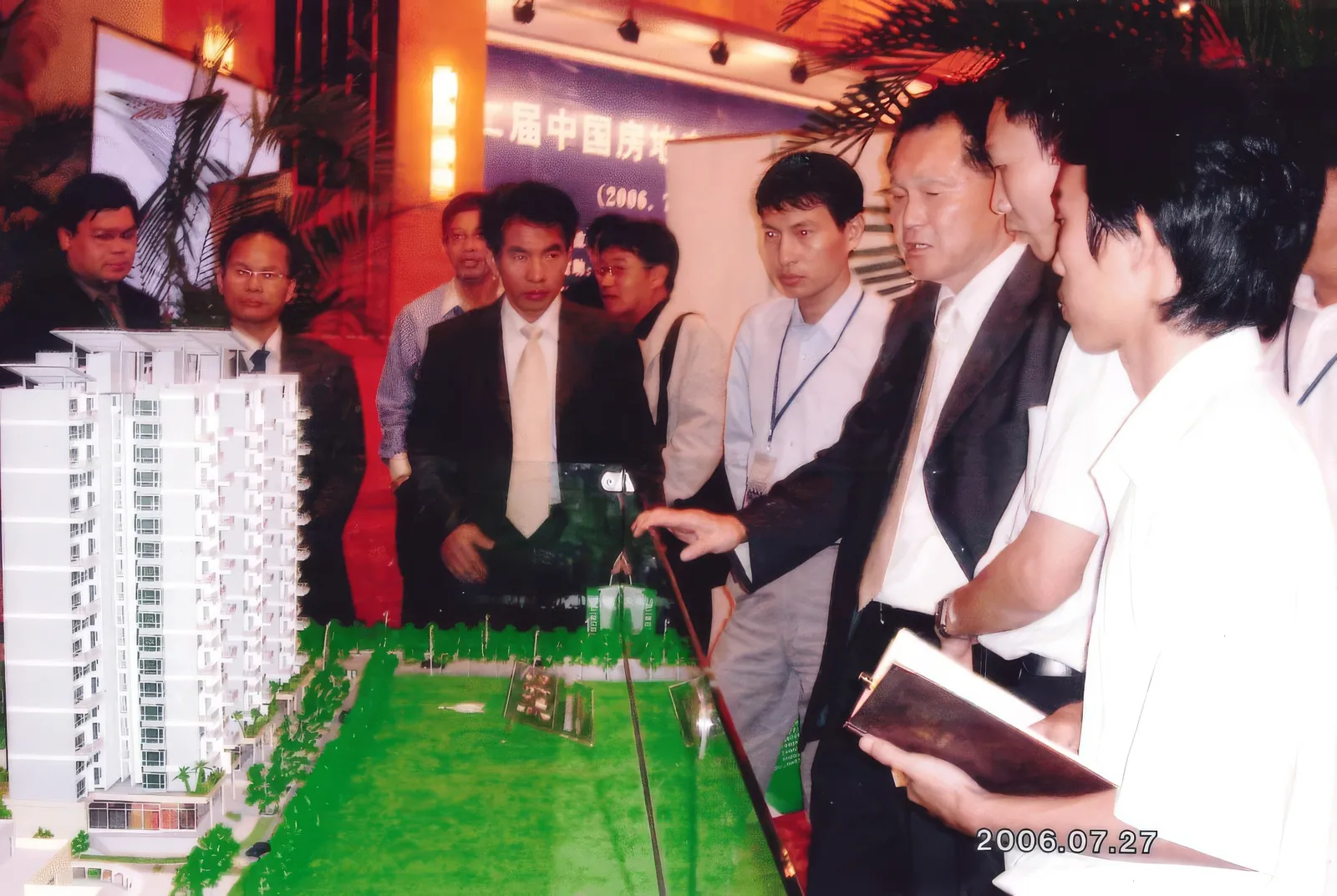 Dr. Cecil Chao showing the guests the model of the building.